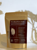 Woodland Berry Tonic package with botanical illustration on a neutral background